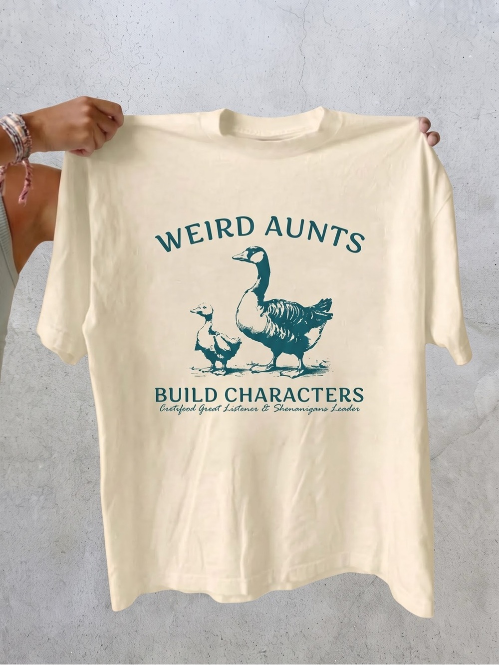 Silly Goose Weird Aunts Build Characters
Cream Graphic Tee